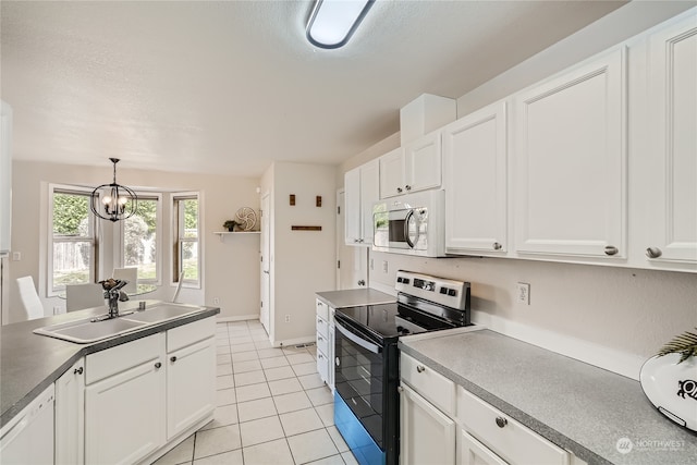 kitchen with pendant lighting, lofted ceiling, sink, white cabinetry, and electric range