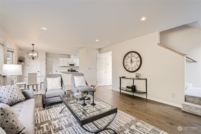 living room featuring dark hardwood / wood-style floors and a chandelier