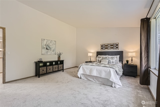 carpeted bedroom with vaulted ceiling