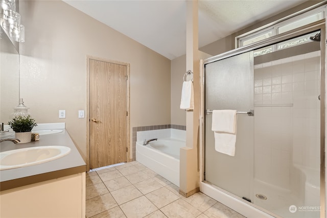 bathroom with vanity, independent shower and bath, vaulted ceiling, a textured ceiling, and tile patterned flooring