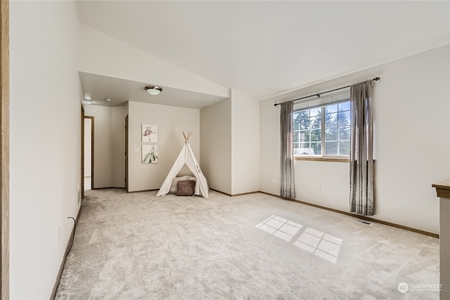 rec room featuring light carpet and lofted ceiling