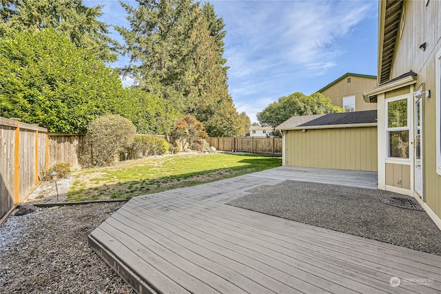 wooden terrace featuring a lawn