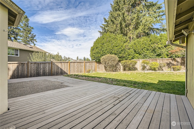 wooden deck with a lawn