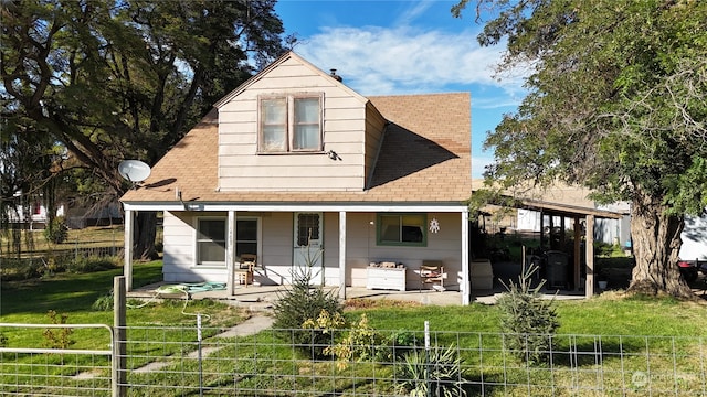 rear view of house with a yard and a patio area