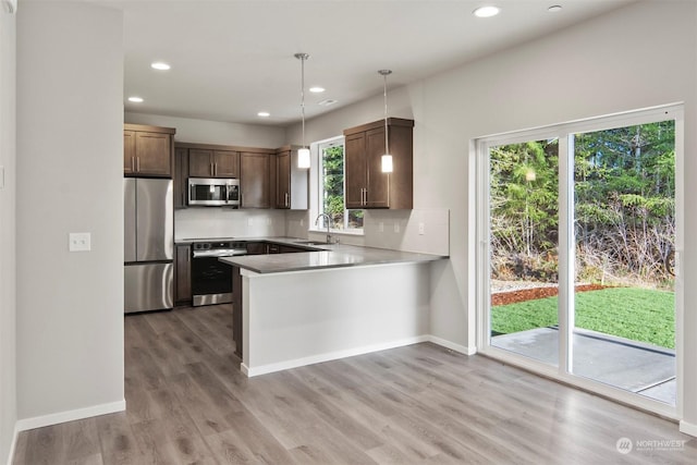 kitchen featuring pendant lighting, sink, plenty of natural light, and appliances with stainless steel finishes