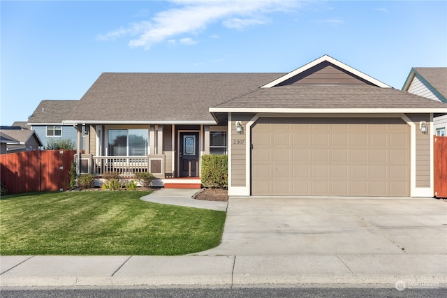 ranch-style home featuring covered porch, a front yard, and a garage