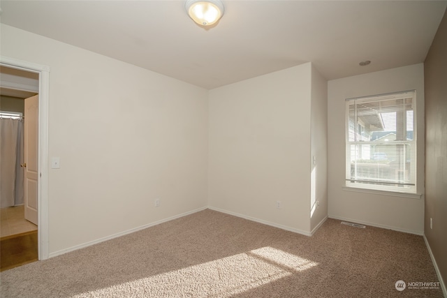 unfurnished room featuring carpet