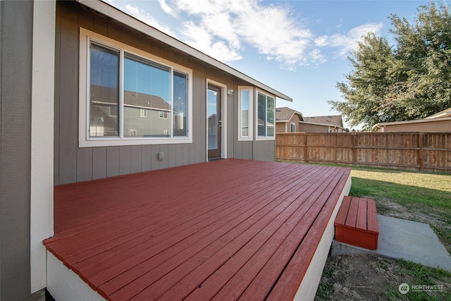 wooden terrace with a lawn