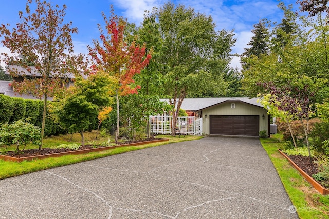 view of front of house with a garage and central AC