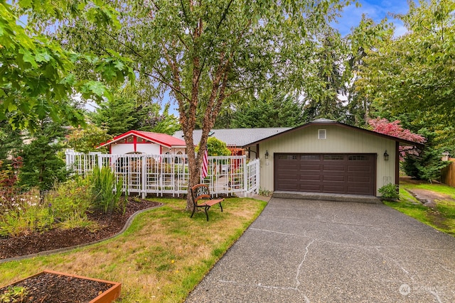 view of front of home with a garage and a front yard