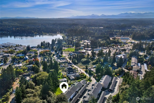 bird's eye view featuring a water and mountain view and a wooded view