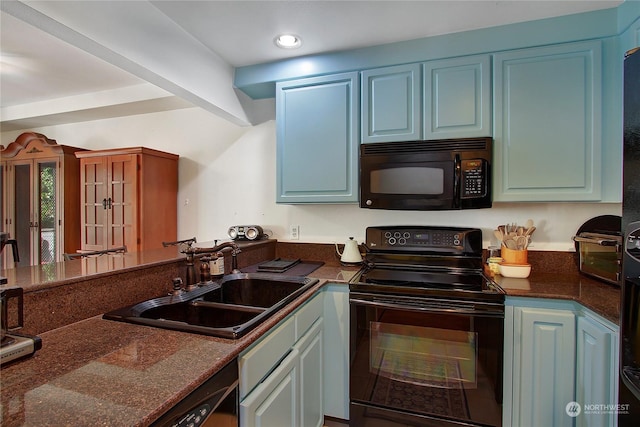 kitchen with a peninsula, recessed lighting, blue cabinets, a sink, and black appliances