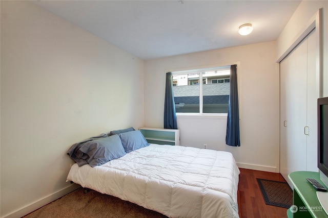 bedroom with wood-type flooring and a closet