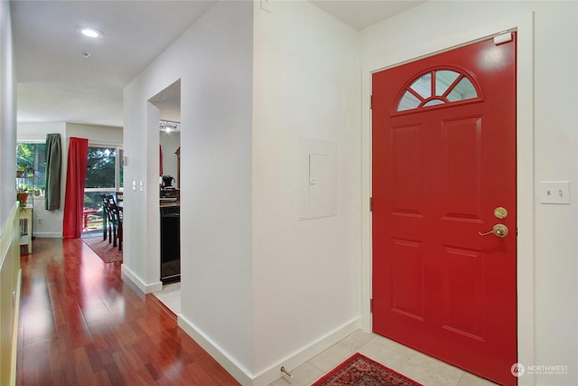 foyer entrance with recessed lighting, baseboards, and light wood-style floors