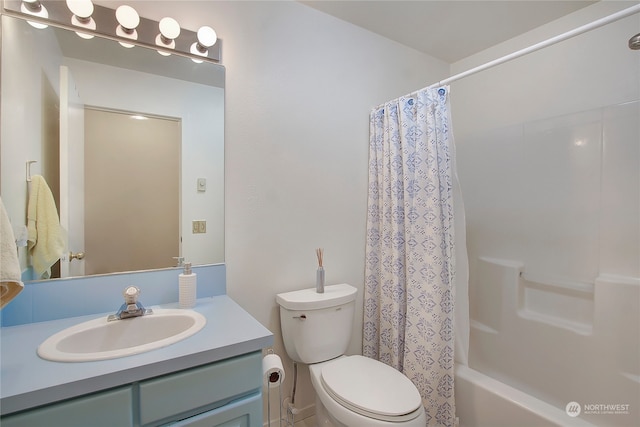 full bathroom featuring vanity, shower / tub combo, and toilet