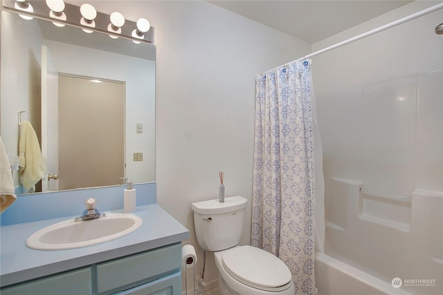 full bathroom featuring vanity, toilet, and shower / tub combo with curtain