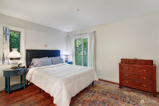 bedroom featuring access to outside and dark wood-type flooring