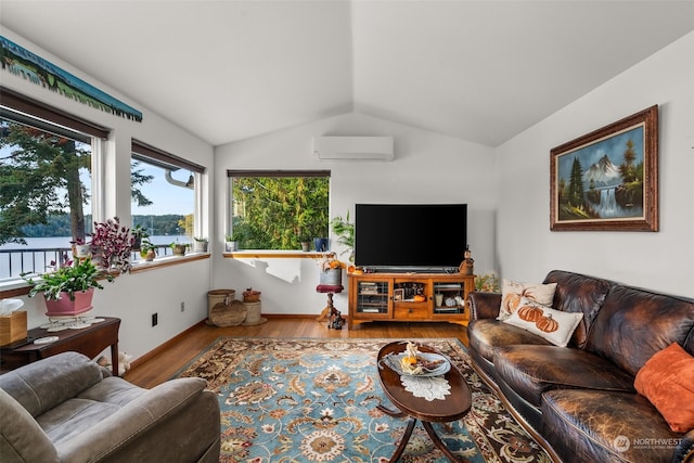 living room with lofted ceiling, an AC wall unit, and hardwood / wood-style floors