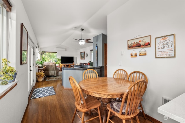 dining room featuring vaulted ceiling, hardwood / wood-style floors, and ceiling fan