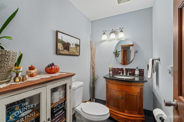 bathroom with vanity and toilet