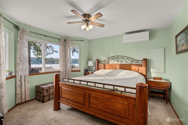 carpeted bedroom with ceiling fan and a wall mounted AC