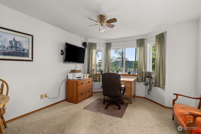 carpeted office space with ceiling fan