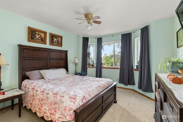 bedroom featuring ceiling fan and light carpet