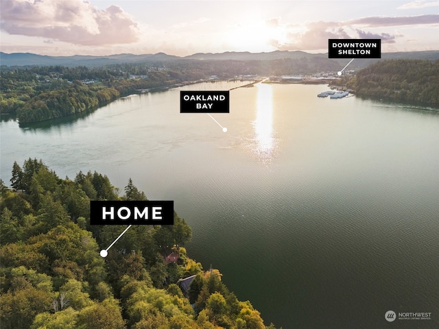 aerial view at dusk with a water and mountain view