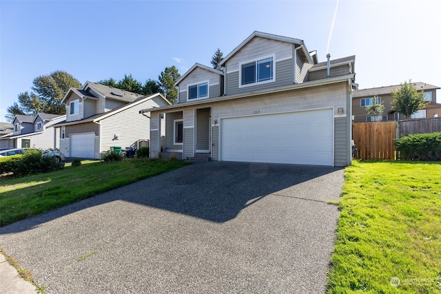 view of front of home featuring a garage and a front lawn