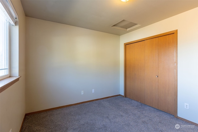 unfurnished bedroom featuring carpet floors and a closet