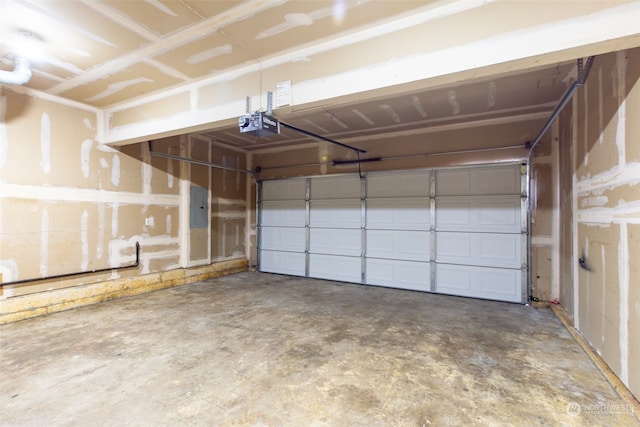 garage featuring electric panel and a garage door opener