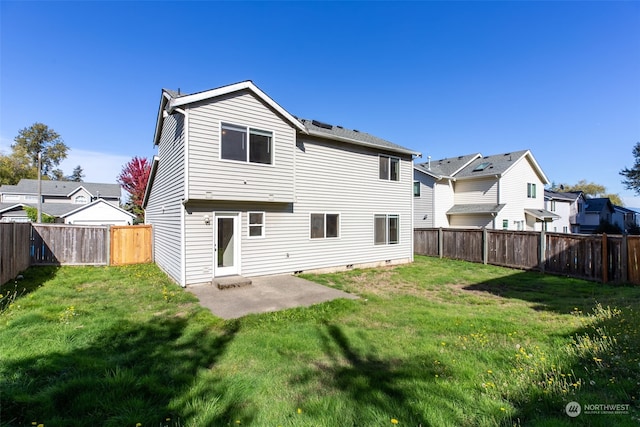 rear view of house with a patio and a lawn