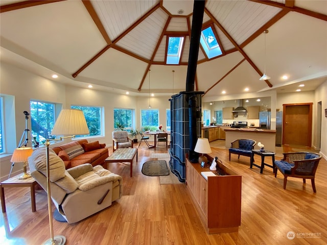 living room featuring beam ceiling, high vaulted ceiling, and light hardwood / wood-style flooring