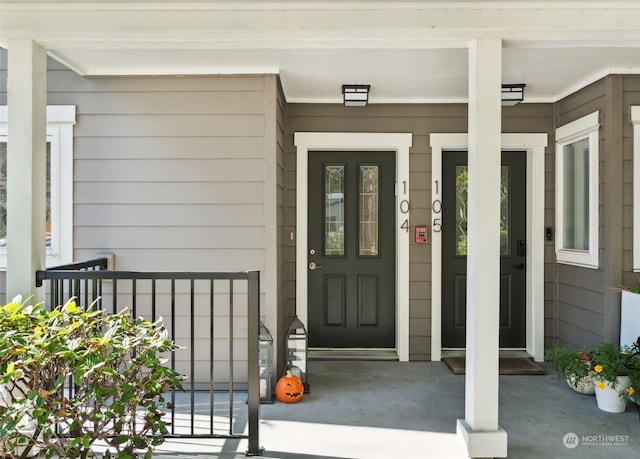 view of exterior entry featuring covered porch