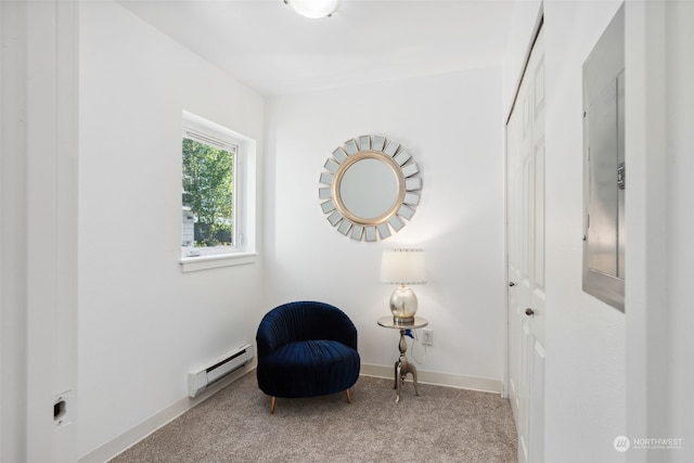 living area with baseboard heating and light carpet