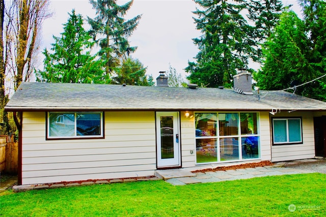 rear view of house with a lawn