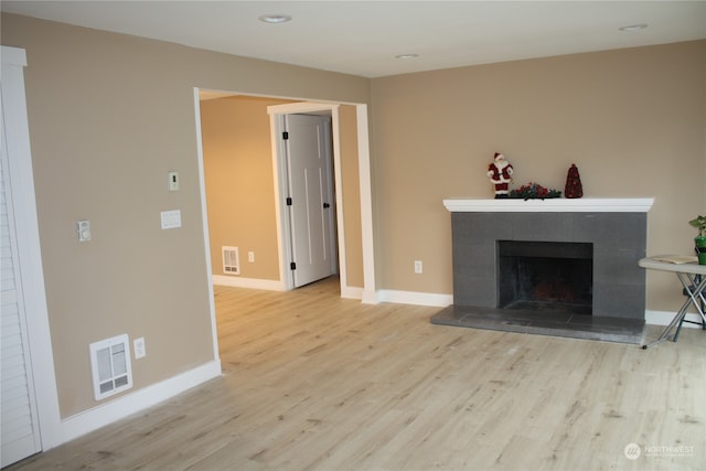 unfurnished living room featuring light hardwood / wood-style floors