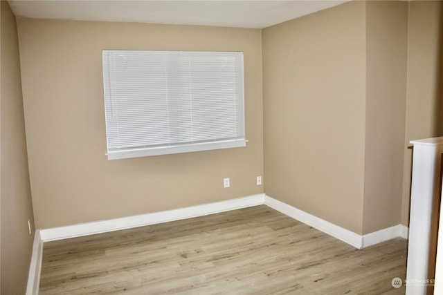 unfurnished room with light wood-type flooring