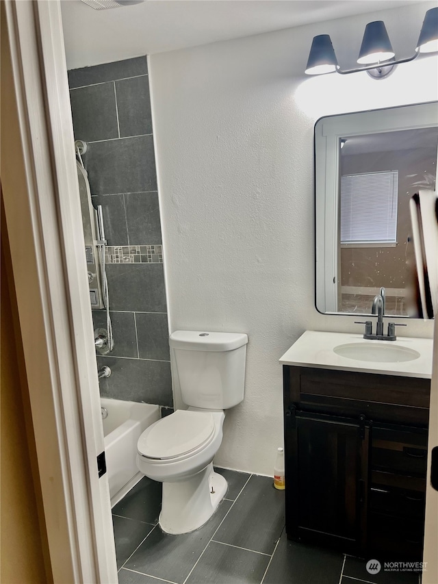 full bathroom with tile patterned flooring, vanity, toilet, and tiled shower / bath combo