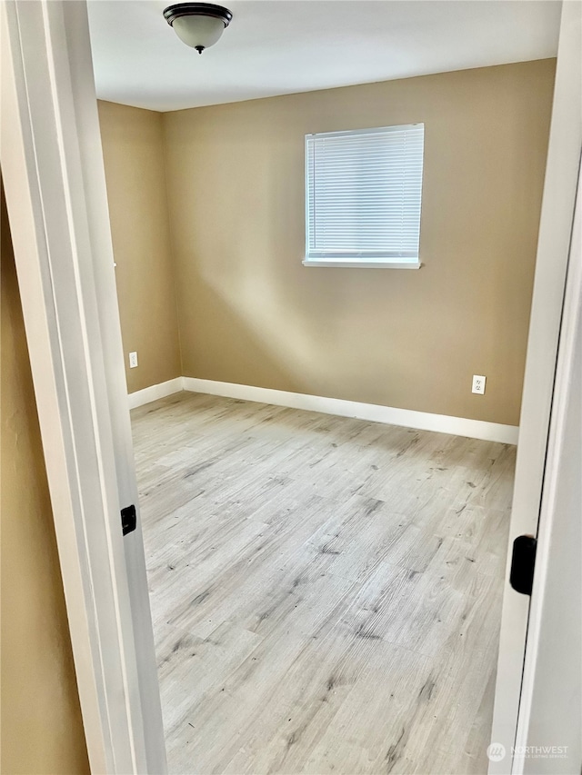 unfurnished room with light hardwood / wood-style floors