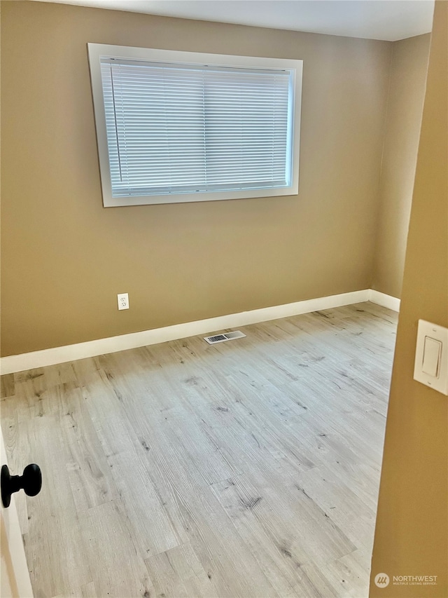 spare room with light wood-type flooring