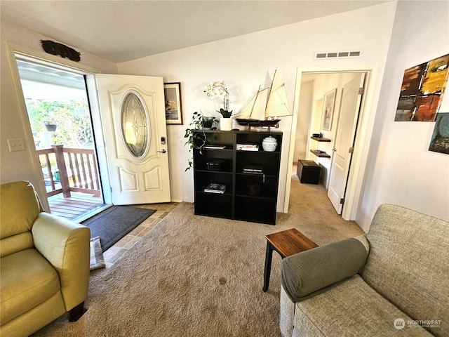 foyer entrance with carpet floors