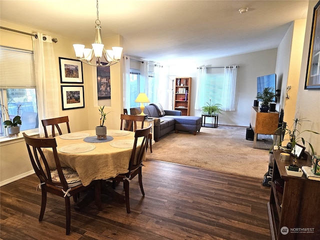 dining room featuring an inviting chandelier and dark wood-type flooring