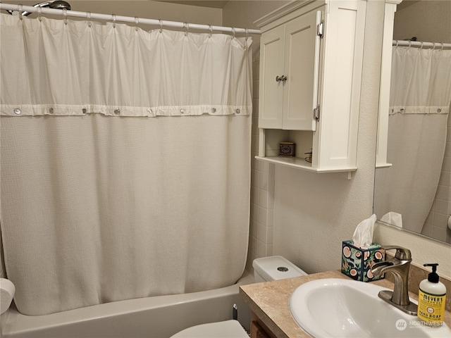 full bathroom with vanity, shower / bath combo, and toilet