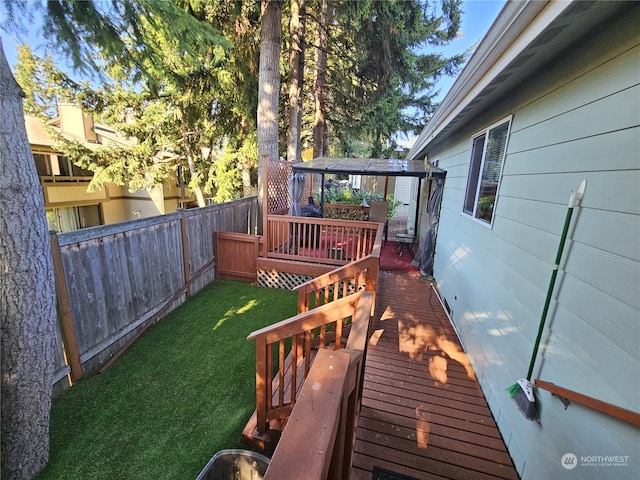 wooden deck featuring a yard