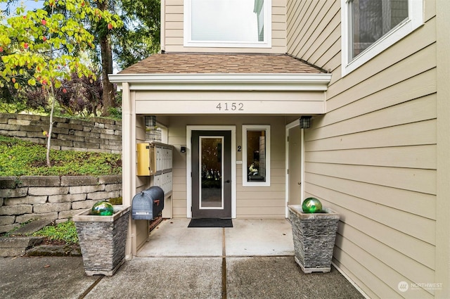 4152 Providence Point Dr SE Unit 207, Issaquah, WA 98029 - view of exterior entry featuring a shingled roof