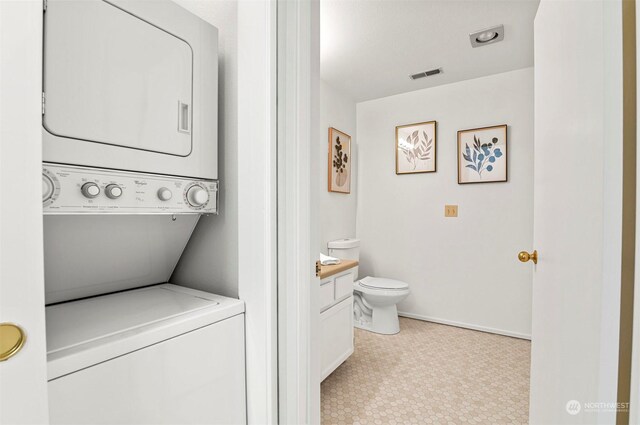 4152 Providence Point Dr SE Unit 207, Issaquah, WA 98029 - bathroom featuring stacked washer / drying machine, vanity, toilet, and baseboards