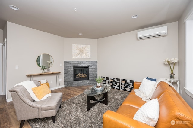 living room featuring a fireplace, dark hardwood / wood-style flooring, and an AC wall unit