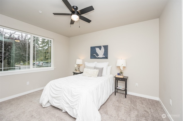 bedroom with ceiling fan and light colored carpet