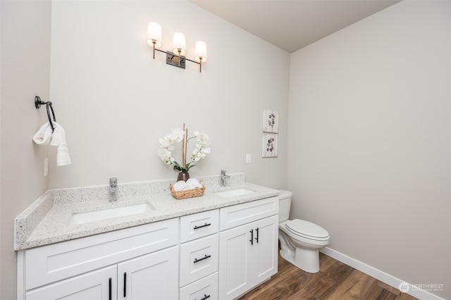 bathroom featuring hardwood / wood-style floors, vanity, and toilet